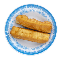 Deep fried dough stick on white dish. Youtiao or Yu Char Kway. Quay. Fried bread stick or popularly known as You Tiao.