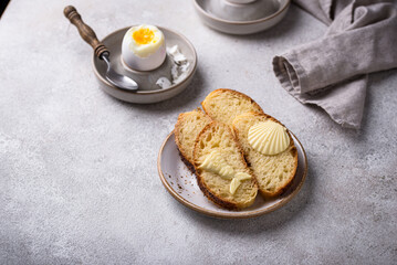 Breakfast with boiled eggs, bread and butter