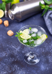Martini cocktail with lime and mint.