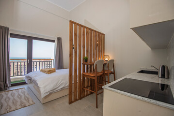 Interior design of luxury studio apartment bedroom with kitchen