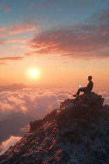 Fototapeta premium Silhouette of a male figure at sunset working on a laptop atop a rocky mountain peak surrounded by clouds.