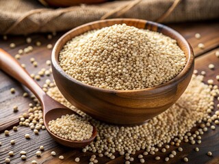 A wooden bowl brimming with tiny, pale millet grains rests on a rustic wooden surface. Scattered grains surround the bowl, enhancing the organic feel of this wholesome food display during daylight