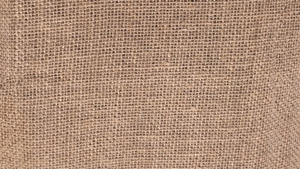 Dark brown background from a textile material with wicker pattern, closeup. Structure of the bronze fabric with texture