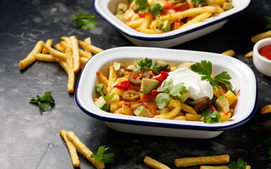 Loaded vegetarian fries with avocado, roasted peppers, jalapeno peppers and cheddar cheese