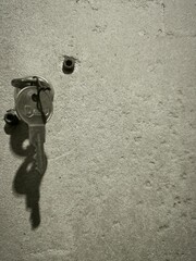  A key inserted into a hole in the wall, suggesting mystery and opportunity, with a hint of curiosity and exploration.