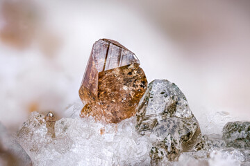 Brown titanite (left) with quartz (on the right) included with Quartz. Specimen from St gotthard massif, switzerland. Micro photography extreme close-up.