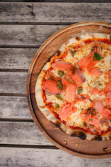 Top view, Pizza with salmon place on wooden tray