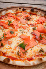 Close up, Pizza with salmon place on wooden tray