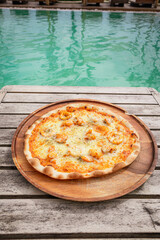Pizza with Tom Yum seafood place on wooden tray