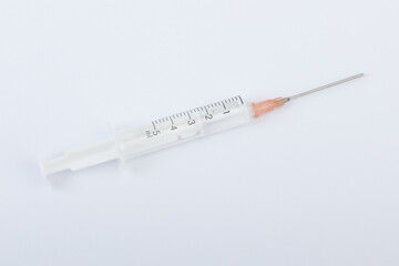 Syringe with needle and vaccine on white background