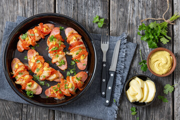 hot sausages baked with cheese, tomato, mustard
