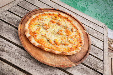High angle, Pizza with Tom Yum seafood place on wooden tray