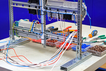 Workplace for the assembly of an electric switchboard in production.