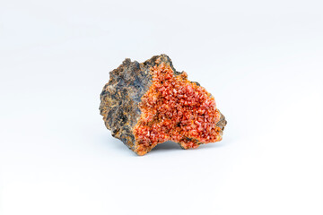 Vanadinite mineral stone showcasing vibrant red crystals on a rustic matrix.
