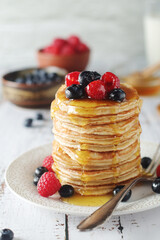Pancakes with berries in rustic style