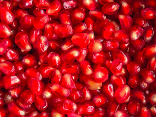 pomegranate grains scattered on the table top view close-up