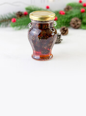 Jam from cones in a beautiful glass jar. A fragrant winter delicacy