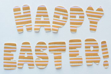 paper sign composed of machine-cut paper letters arranged to say: Happy Easter!