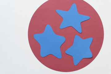 machine-cut circle and star shapes in blue and red on blank paper