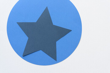 machine-cut blue circle and star on blank paper