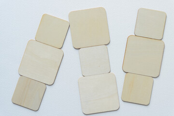 laser-cut wooden square shapes arranged on blank paper