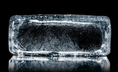 Natural textured ice block with internal cavity isolated on a black background with reflection.