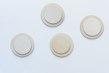 laser-cut wooden round shapes arranged on blank paper