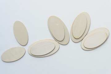 laser-cut wooden oval shapes arranged on blank paper