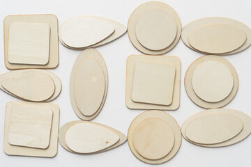 set of laser-cut wooden shapes arranged on blank paper