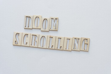 laser-cut wooden stencil font letters sign: doom scrolling