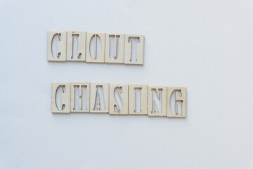 laser-cut wooden stencil font letters sign: clout chasing 