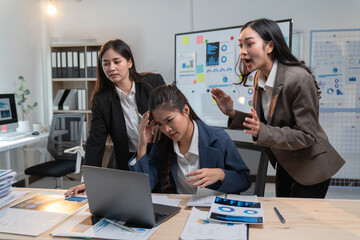 Asian businesswomen are having a stressful time at work while being scolded by their manager for a...