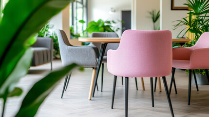Modern dining area with colorful chairs and lush indoor plants, creating a cozy ambiance.