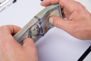 doctor holding a hundred dollar bill