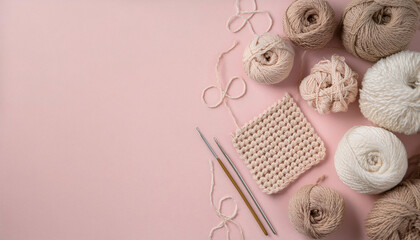 Crochet essentials flatlay featuring soft-toned yarns, crochet hooks, and a finished square on a pastel pink background