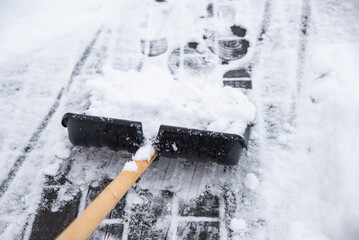 clearing snow from the sidewalk