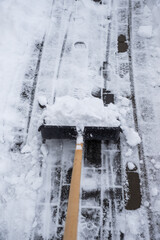 clearing snow from the sidewalk