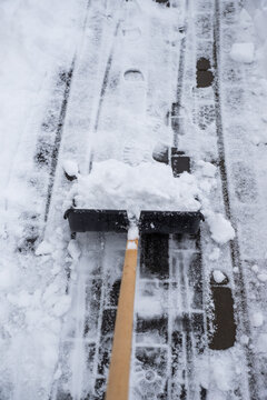 clearing snow from the sidewalk