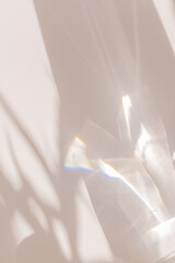 Sunlight background, abstract backdrop with light and shadow, glare and shine on paper texture, rainbow flare, beige color trend aesthetic wallpaper. Natural beams light, caustics effect