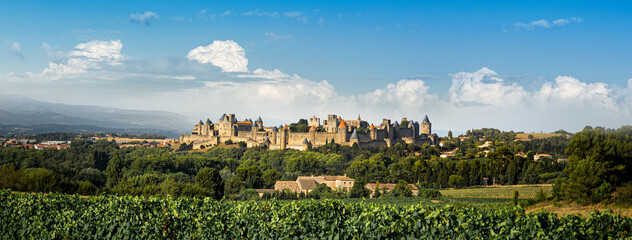Carcassonne fortress with towers and city walls around the old town, panoramic landscape of great Medieval castle, France.