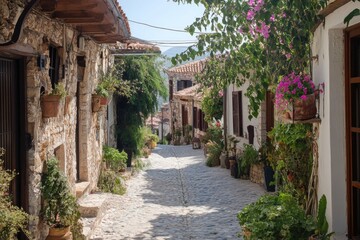 Fototapeta premium Picturesque cobblestone street winding through charming village with stone houses and lush greenery