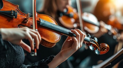 Close up on hand of unrecognizable female orchestra musician playing violin with bow during concert on stage, focus on hand and tailpiece