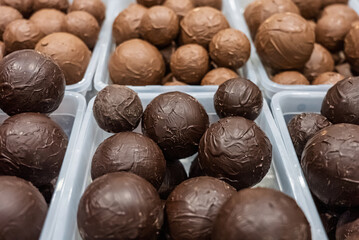 Close up of assorted chocolate truffles in various colors and textures. Colorful chocolate balls....