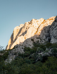 sun shining on th  rock climbing wall in paklenica national park