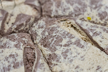 Halva is a traditional Middle Eastern confection made primarily from sesame paste and sugar. Cake with rich, sweet flavor and crumbly texture. Halva cake. Halva dessert and a snack.