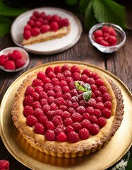 Finnish dessert of raspberry pie (vadelmapiirakka) with a golden crust and fresh raspberries