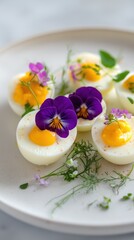 Gourmet deviled eggs garnished with edible flowers on a white plate