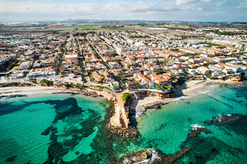 Aerial drone point of view, Torre de la Horadada townscape during sunny day, residential houses...