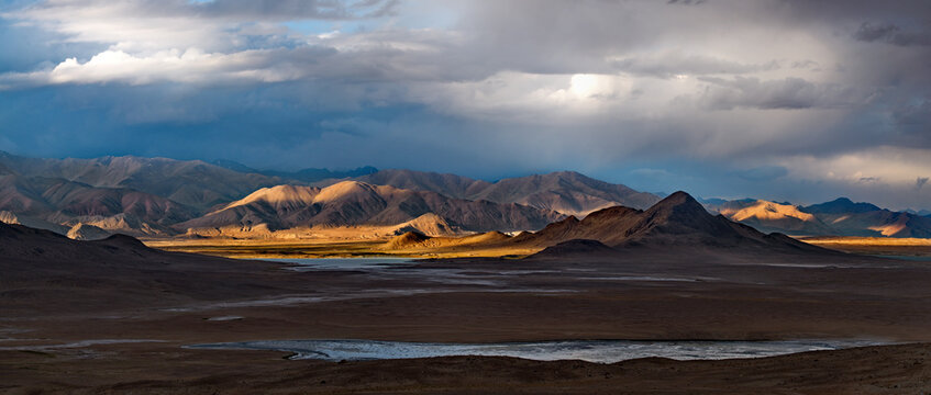 Tajikistan. A picturesque sunset in the valley of the mountainous desert lake Bulunkul on the northeastern section of the Pamir tract.
