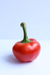 Red pepper on a white background. Close-up, selective focus.